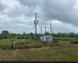 A field with power lines and telephone poles.